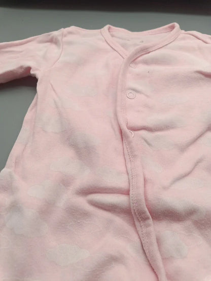 Detail der schrägen Druckknopfleiste des rosa Baby-Schlafanzugs