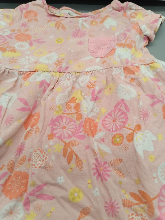 Detailaufnahme des bunten Blumenmusters und des kleinen Brusttäschchens am hellrosa Mädchenkleid in Größe 104