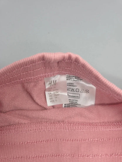 H&M Marken- und Pflegeetikett der roséfarbenen Babyhose